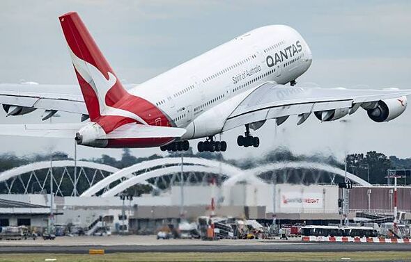 Man charged after allegedly trying to open Qantas plane door mid-flight